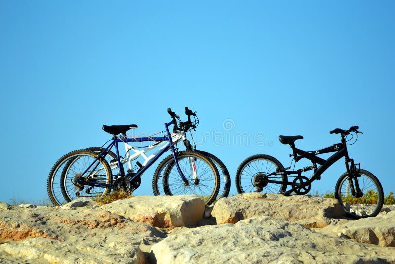 Three bicycles on the top of a rocky hill. Three bicycles on the top of a rocky hill.