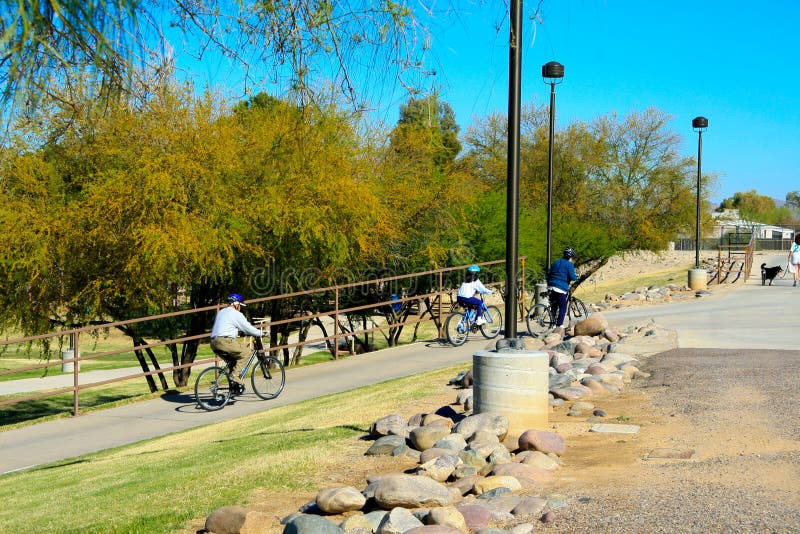 Bicycles going up small hill on multi-use pathway at Vista Del Camino Park Scottsdale Arizona. Bicycles going up small hill on multi-use pathway at Vista Del Camino Park Scottsdale Arizona