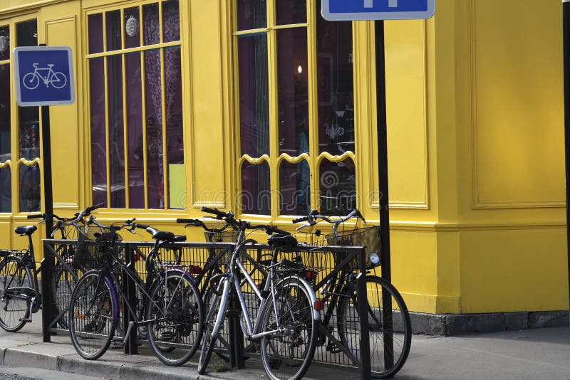 In Paris France near the Canal St Martin on the Seine bicycles await to be used. In Paris France near the Canal St Martin on the Seine bicycles await to be used