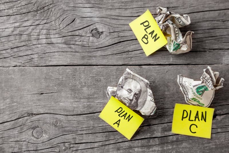 Failed business plan A, B and C. Minted dollar banknotes on a wooden desk royalty free stock photos Failed business plan A, B and C. Minted dollar banknotes on a wooden desk royalty free stock photos