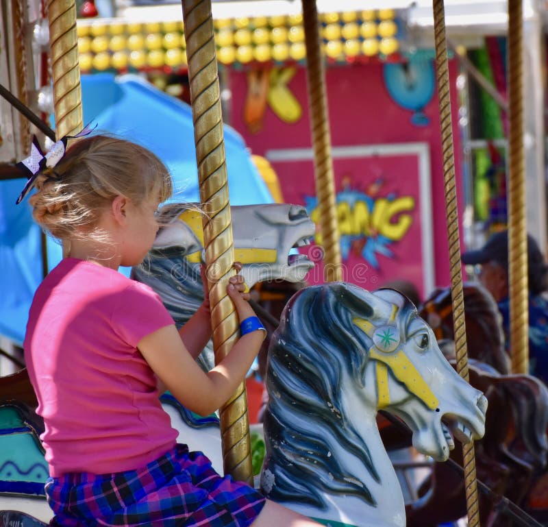 Fair Time: Cowgirl on a Carousel at the Benton Franklin County Fair and Rodeo, Kennewick, Washington royalty free stock image Fair Time: Cowgirl on a Carousel at the Benton Franklin County Fair and Rodeo, Kennewick, Washington royalty free stock image