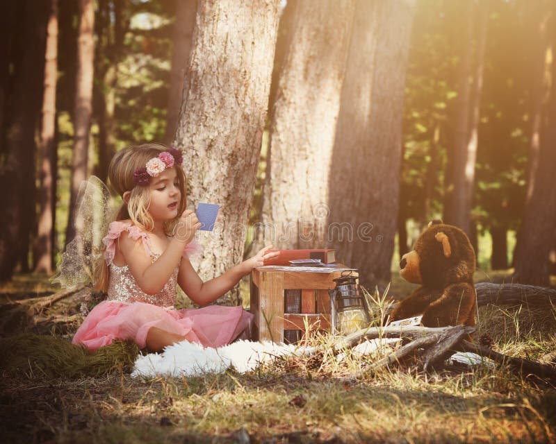 Fairy Girl Playing wiht Teddy Bear in Woods