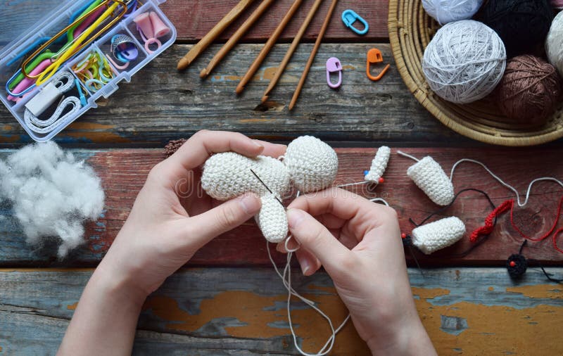 Making crochet white dog. The toy for babies or trinket. On the table threads, needles, hook, cotton yarn. Handmade gift. Income from hobby. DIY crafts concept. Step 2 - to sew all details of toy, knitting, wool, background, pattern, textile, crocheting, color, colorful, homemade, design, sewing, needlework, ball, fashion, material, creative, blue, woolen, rainbow, art, red. Making crochet white dog. The toy for babies or trinket. On the table threads, needles, hook, cotton yarn. Handmade gift. Income from hobby. DIY crafts concept. Step 2 - to sew all details of toy, knitting, wool, background, pattern, textile, crocheting, color, colorful, homemade, design, sewing, needlework, ball, fashion, material, creative, blue, woolen, rainbow, art, red