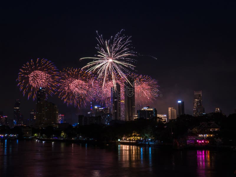 Bangkok, Thailand - January 1, 2024 : Fireworks is beautiful at night, seen in the New Year holidays for tourists to take pictures during public travel. Bangkok, Thailand - January 1, 2024 : Fireworks is beautiful at night, seen in the New Year holidays for tourists to take pictures during public travel