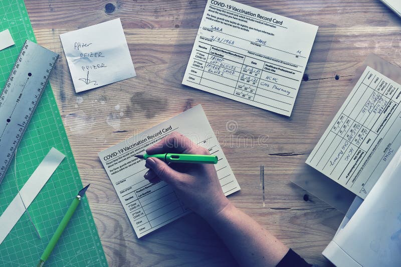 Fake covid vaccination record card. Forgery of health certificate confirming vaccinations against covid-19. Printed