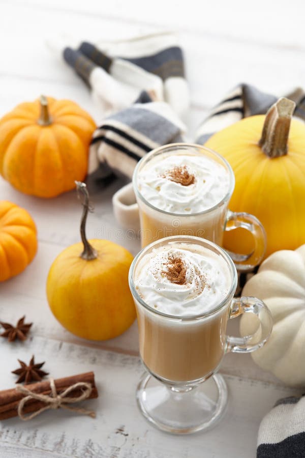 Fall Pumpkin Spice Latte with Whipped Cream on White Wooden Background