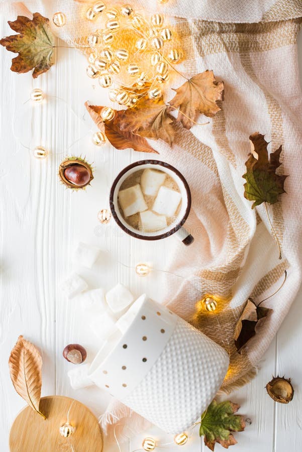 Fall still life with yellow leaves, coffe with marshmallows and