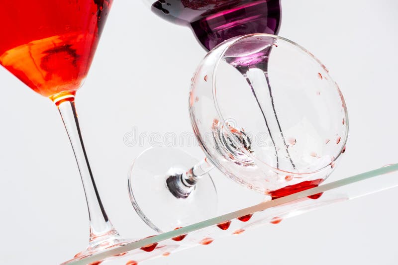 Glass Martini Glass and Spilled Liquid on a Pinkgreen Background