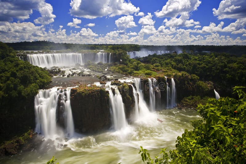 Iguassu Falls is the largest series of waterfalls on the planet, located in Brazil, Argentina, and Paraguay in South America. During the rainy season one can see as many as 275 separate waterfalls cascading along the edges of 2,700 meters or 1.6 miles cliffs. Argentines spells this wonder, Ã¬IguazuÃ®, the Brazilians, Ã¬Igaucu.Ã® Both versions are globally correct and widely used. South America. Iguassu Falls is the largest series of waterfalls on the planet, located in Brazil, Argentina, and Paraguay in South America. During the rainy season one can see as many as 275 separate waterfalls cascading along the edges of 2,700 meters or 1.6 miles cliffs. Argentines spells this wonder, Ã¬IguazuÃ®, the Brazilians, Ã¬Igaucu.Ã® Both versions are globally correct and widely used. South America