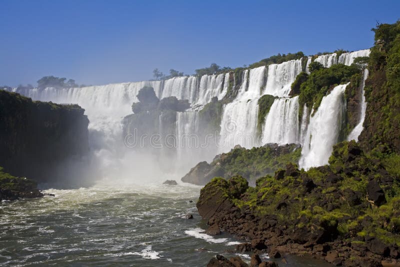 Iguassu Falls is the largest series of waterfalls on the planet, located in Brazil, Argentina, and Paraguay in South America. During the rainy season one can see as many as 275 separate waterfalls cascading along the edges of 2,700 meters or 1.6 miles cliffs. Argentines spells this wonder, Ã¬IguazuÃ®, the Brazilians, Ã¬Igaucu.Ã® Both versions are globally correct and widely used. South America. Iguassu Falls is the largest series of waterfalls on the planet, located in Brazil, Argentina, and Paraguay in South America. During the rainy season one can see as many as 275 separate waterfalls cascading along the edges of 2,700 meters or 1.6 miles cliffs. Argentines spells this wonder, Ã¬IguazuÃ®, the Brazilians, Ã¬Igaucu.Ã® Both versions are globally correct and widely used. South America
