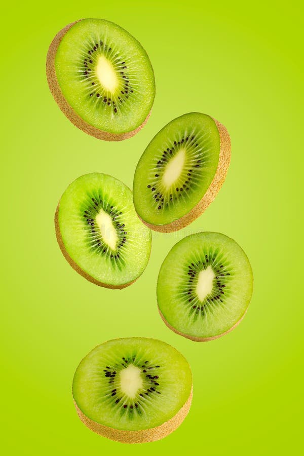 Falling Green Kiwi Isolated on Green Background. Stock Image ...