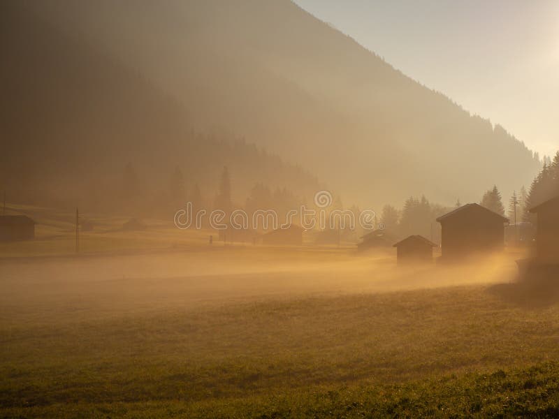 Fallsonnenaufgang auf den Alpen mit Feuchtigkeit in der Luft stockfotos Fallsonnenaufgang auf den Alpen mit Feuchtigkeit in der Luft stockfotos