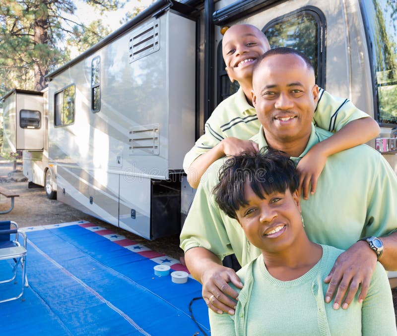 Happy African American Family In Front of Their Beautiful RV At The Campground. Happy African American Family In Front of Their Beautiful RV At The Campground.
