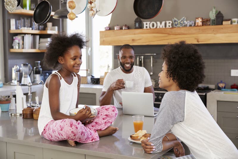 Family Sitting In Kitchen Enjoying Morning Breakfast Together. Family Sitting In Kitchen Enjoying Morning Breakfast Together