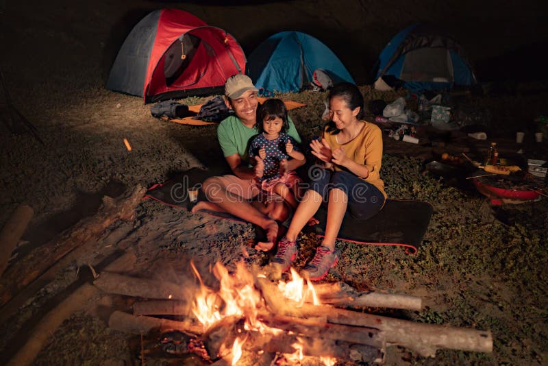 Happy family at camping with campfire at night. Happy family at camping with campfire at night