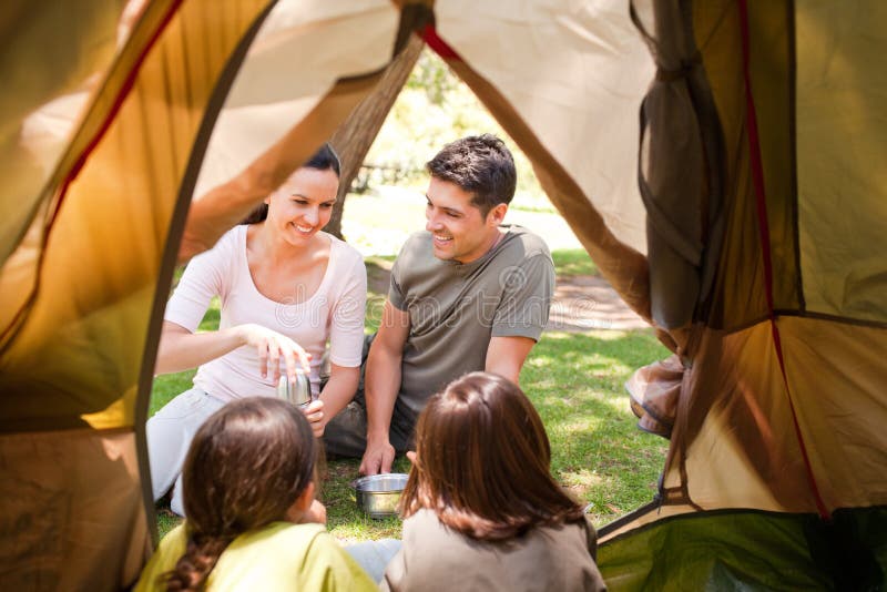 Happy family camping in the park having fun together. Happy family camping in the park having fun together