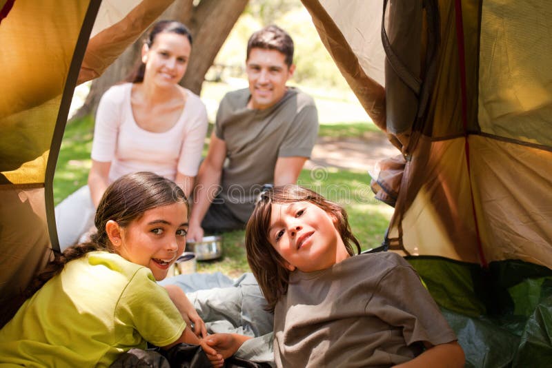 Happy caucasian family camping in the park. Happy caucasian family camping in the park