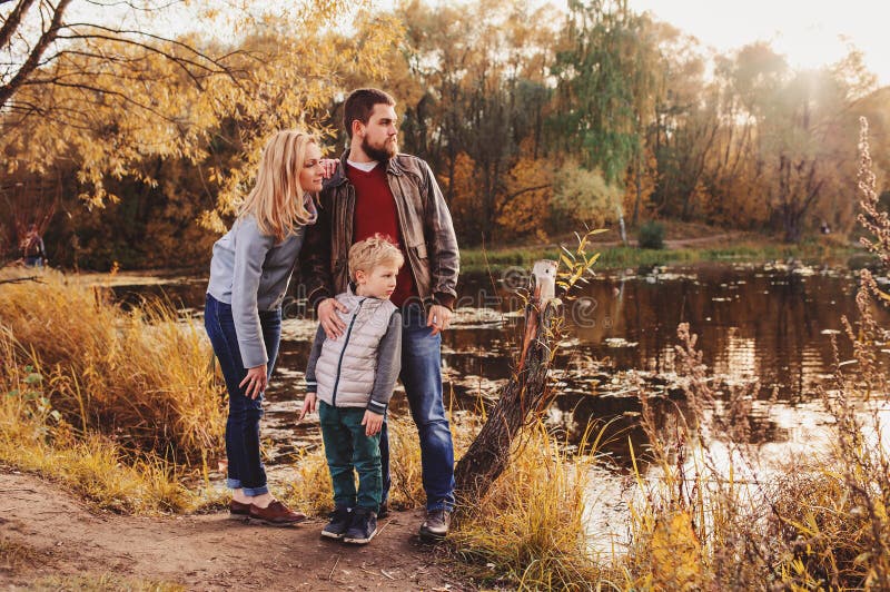 Happy family spending time together outdoor. Lifestyle capture, rural cozy scene. Father, mother and son walking in forest. Happy family spending time together outdoor. Lifestyle capture, rural cozy scene. Father, mother and son walking in forest