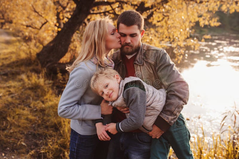 Happy family spending time together outdoor. Lifestyle capture, rural cozy scene. Father, mother and son walking in forest. Happy family spending time together outdoor. Lifestyle capture, rural cozy scene. Father, mother and son walking in forest