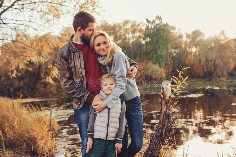 Happy family spending time together outdoor. Lifestyle capture, rural cozy scene. Father, mother and son walking in forest. Happy family spending time together outdoor. Lifestyle capture, rural cozy scene. Father, mother and son walking in forest