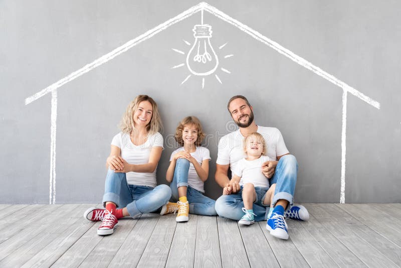 Famiglia felice con due bambini che giocano nella nuova casa immagini stock libere da diritti
