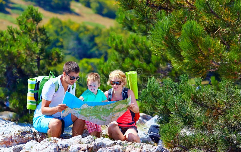 Happy tourist family in mountains discussing the route. Happy tourist family in mountains discussing the route