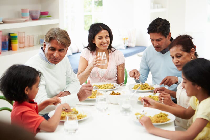 Famiglia indiana della multi generazione che mangia pasto a casa