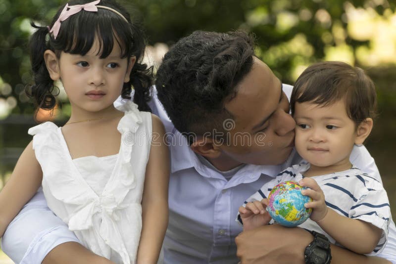 Family bonding concept, father and his 2 children, asian, boy, brother, care, casual, cheerful, childhood, daughter, enjoyment, environmental, face, fun, garden, girl, grass, happiness, holiday, kids, leisure, lifestyle, love, malay, malaysian, mother, muslim, outdoors, parenthood, parenting, parents, park, people, picnic, recreational, relationship, relax, relaxation, sister, smiling, son, togetherness, woman, women, well-being, green, emotion. Family bonding concept, father and his 2 children, asian, boy, brother, care, casual, cheerful, childhood, daughter, enjoyment, environmental, face, fun, garden, girl, grass, happiness, holiday, kids, leisure, lifestyle, love, malay, malaysian, mother, muslim, outdoors, parenthood, parenting, parents, park, people, picnic, recreational, relationship, relax, relaxation, sister, smiling, son, togetherness, woman, women, well-being, green, emotion