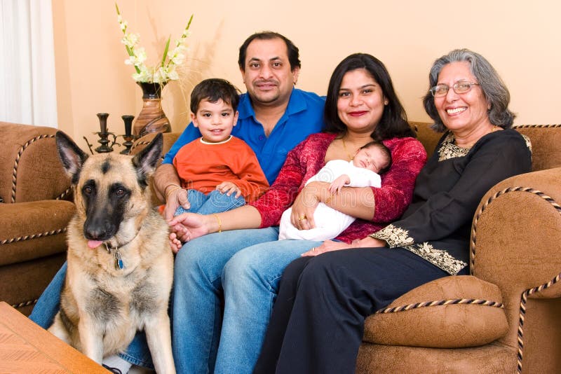 An East-Indian family sits in their living room. An East-Indian family sits in their living room