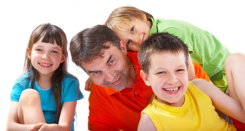 Three children pose with their father/uncle, grinning widely. Three children pose with their father/uncle, grinning widely.