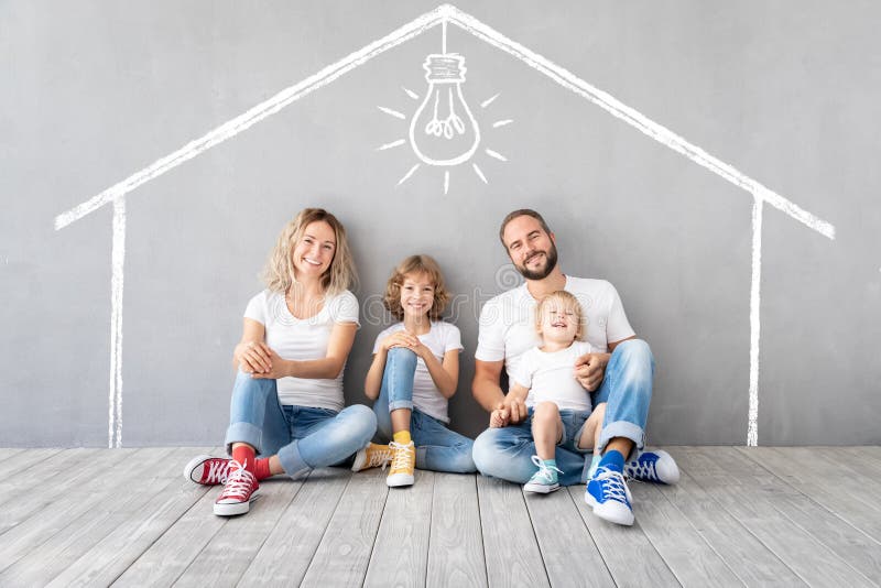 Happy family with two kids playing into new home. Father, mother and children having fun together. Moving house day and real estate concept. Happy family with two kids playing into new home. Father, mother and children having fun together. Moving house day and real estate concept
