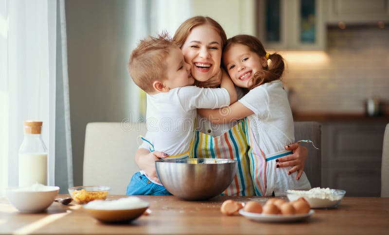 Familia feliz en cocina la madre y los ni? os que preparan la pasta, cuecen las galletas foto de archivo libre de regalías