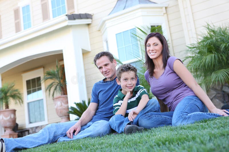 A happy family having fun outdoors in front of their home. A happy family having fun outdoors in front of their home