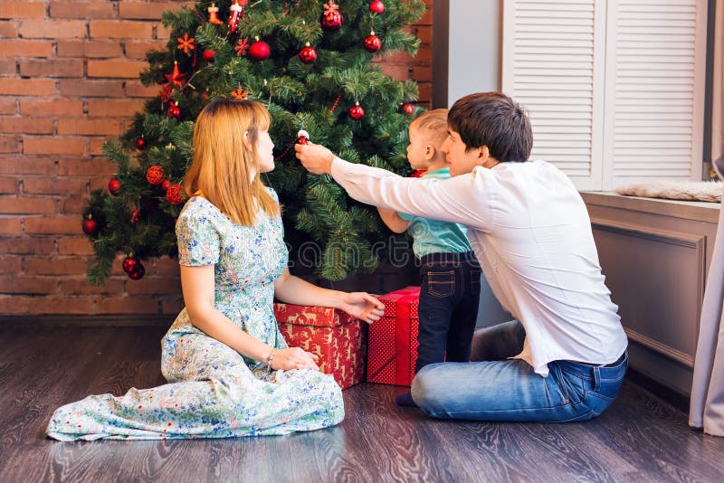 Familia feliz que juega con las bolas de la Navidad en casa fotografía de archivo libre de regalías Familia feliz que juega con las bolas de la Navidad en casa fotografía de archivo libre de regalías