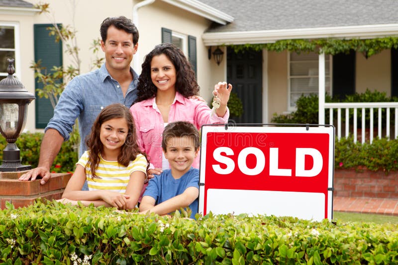 Happy hispanic family outside home with sold sign holding keys smiling at camera. Happy hispanic family outside home with sold sign holding keys smiling at camera