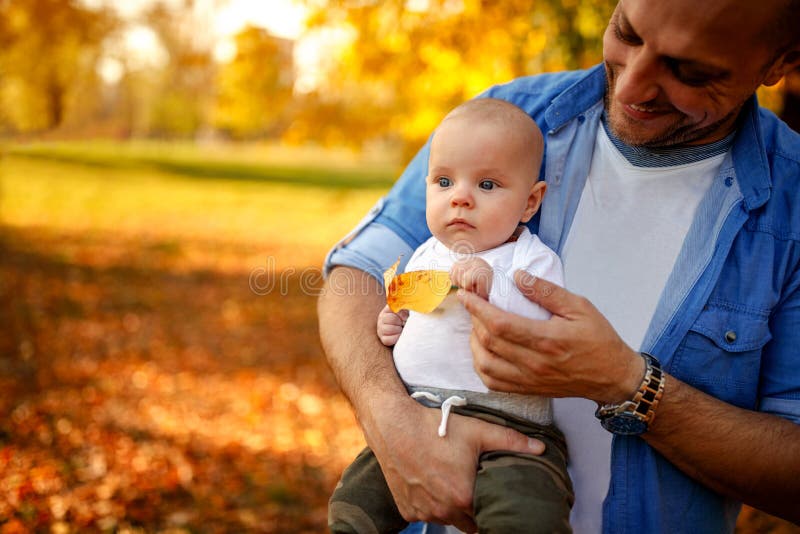 Familia que goza en parque-padre del otoño con el niño imagen de archivo Familia que goza en parque-padre del otoño con el niño imagen de archivo