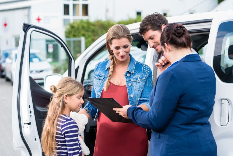 Happy family being advised by salesperson buying car. Happy family being advised by salesperson buying car