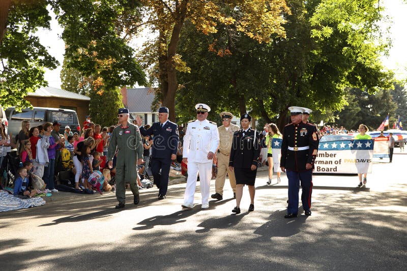 Families watch US military veterans walk past at a United States independence day celebration parade in Idaho Falls, Idaho.  The city parks and recreation department hosts many activities, and social events during the summer for youth and adults. Families watch US military veterans walk past at a United States independence day celebration parade in Idaho Falls, Idaho.  The city parks and recreation department hosts many activities, and social events during the summer for youth and adults.