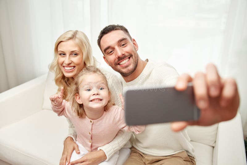 Familj som tar selfie med den hemmastadda smartphonen arkivfoton Familj som tar selfie med den hemmastadda smartphonen arkivfoton