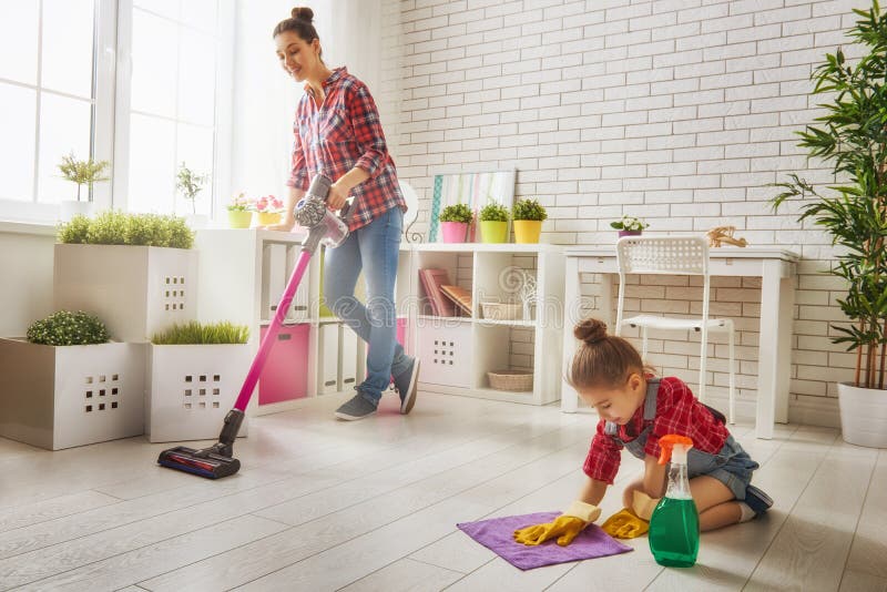 Happy family cleans the room. Mother and daughter do the cleaning in the house. A young women and a little child girl wiped the dust and vacuumed the floor. Happy family cleans the room. Mother and daughter do the cleaning in the house. A young women and a little child girl wiped the dust and vacuumed the floor.