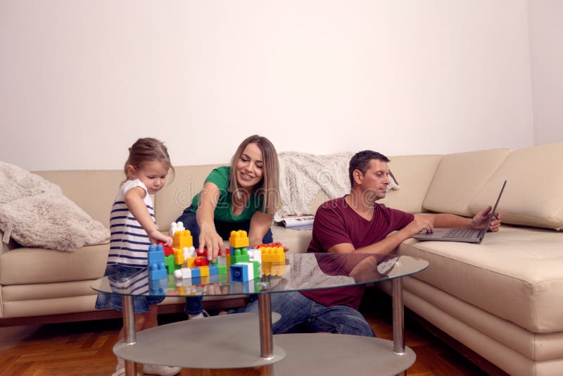 Famille affectueuse heureuse parents jouant avec sa fille ? la maison photo libre de droits Famille affectueuse heureuse parents jouant avec sa fille ? la maison photo libre de droits
