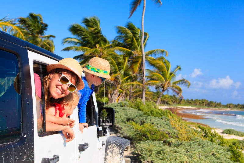 Famille conduisant la voiture tous terrains sur la plage tropicale images stock Famille conduisant la voiture tous terrains sur la plage tropicale images stock