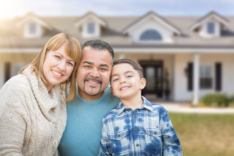 Mixed Race Family In Front Yard of a Beautiful House and Property. Mixed Race Family In Front Yard of a Beautiful House and Property.