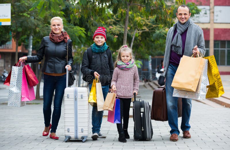 Family of tourists with kids carrying a shopping bags outdoors. Family of tourists with kids carrying a shopping bags outdoors