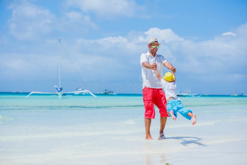 Famille heureuse se reposant à la plage en été Père avec le fils se reposant sur la plage Père et son petit fils adorable dessus photos libres de droits Famille heureuse se reposant à la plage en été Père avec le fils se reposant sur la plage Père et son petit fils adorable dessus photos libres de droits