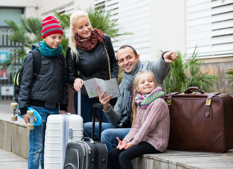 Famille vérifiant la direction dans la carte images stock Famille vérifiant la direction dans la carte images stock