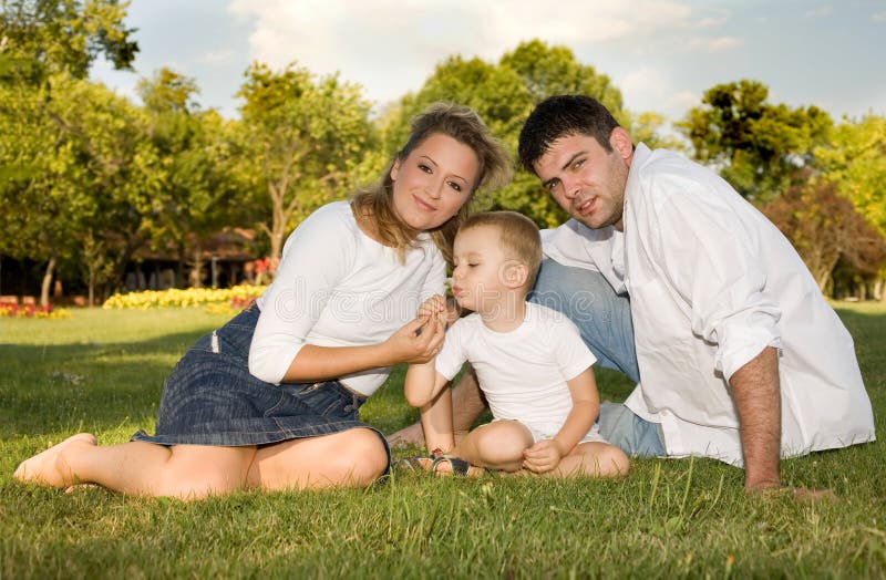 Happy family at the park on a sunny day. Happy embracing couple stock images, royalty-free photos and pictures