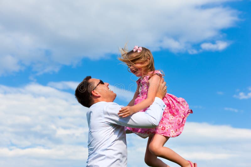 Family affairs - father and daughter playing in su. 