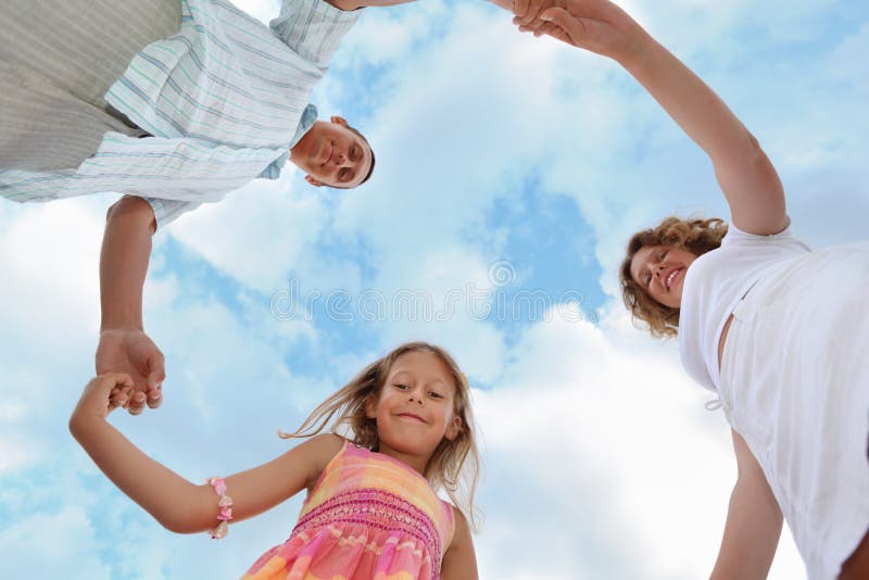 Family against sky, foreshortening from below