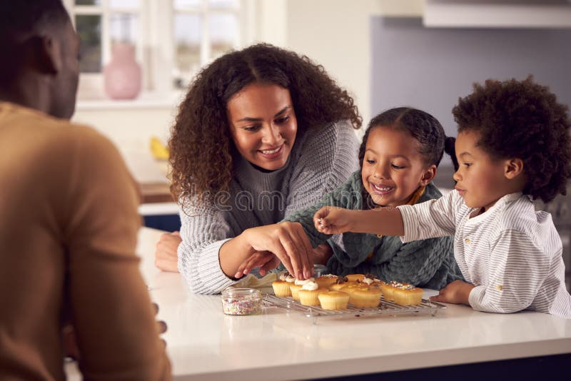 Family Baking Cupcakes Sitting Around Kitchen Counter at Home Stock Image Image of people
